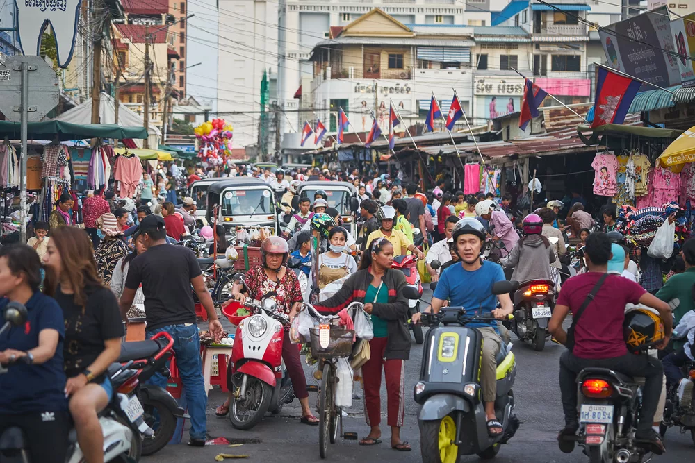 Busy street scene in Phnom Penh used to illustrate article about crypto's development in Cambodia.