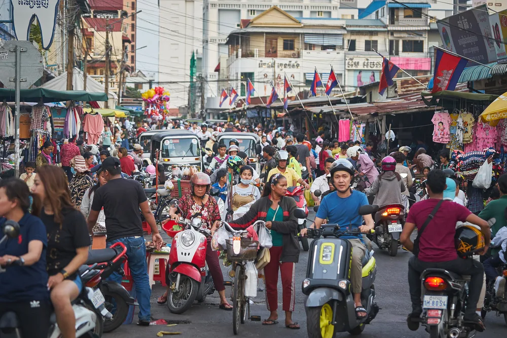 Busy street scene in Phnom Penh used to illustrate article about crypto's development in Cambodia.